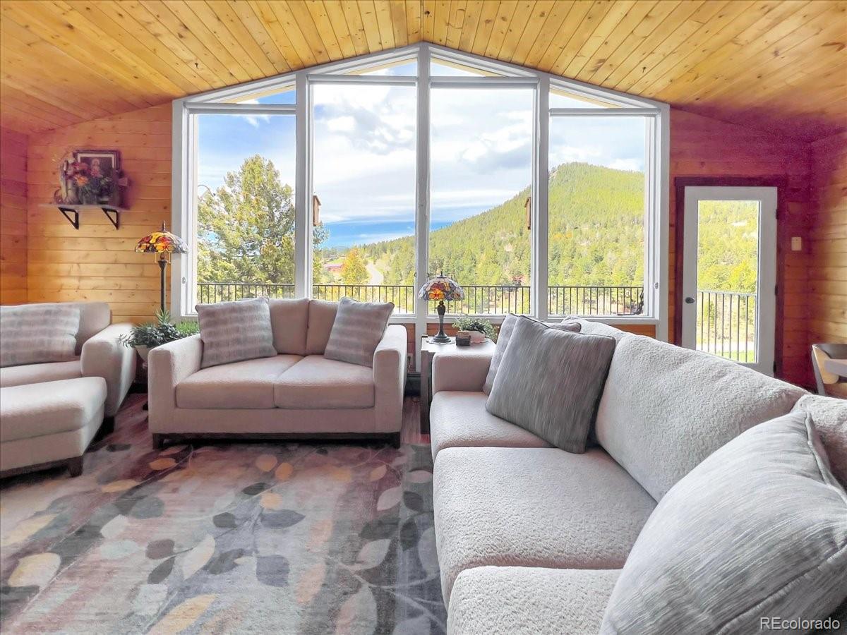22155 Cook Lane Morrison, CO 80465 - Photo 4 of 28 a living room with furniture and a large window