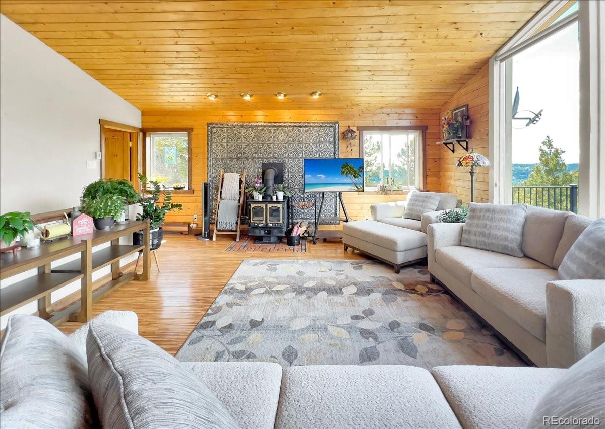 22155 Cook Lane Morrison, CO 80465 - Photo 8 of 28 a living room with furniture and a large window