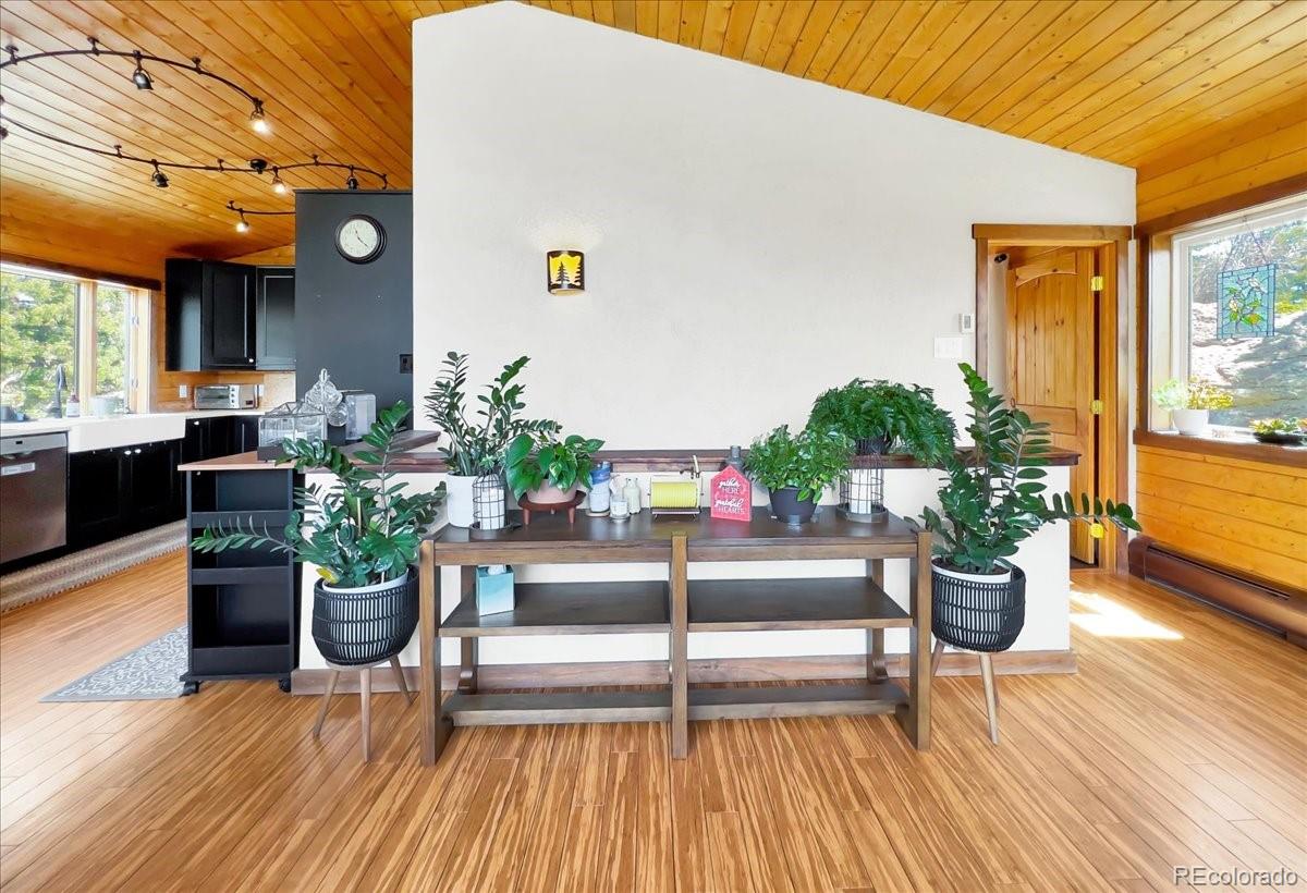 22155 Cook Lane Morrison, CO 80465 - Photo 9 of 28 a view of a dining tables and chairs in the patio in front of a house
