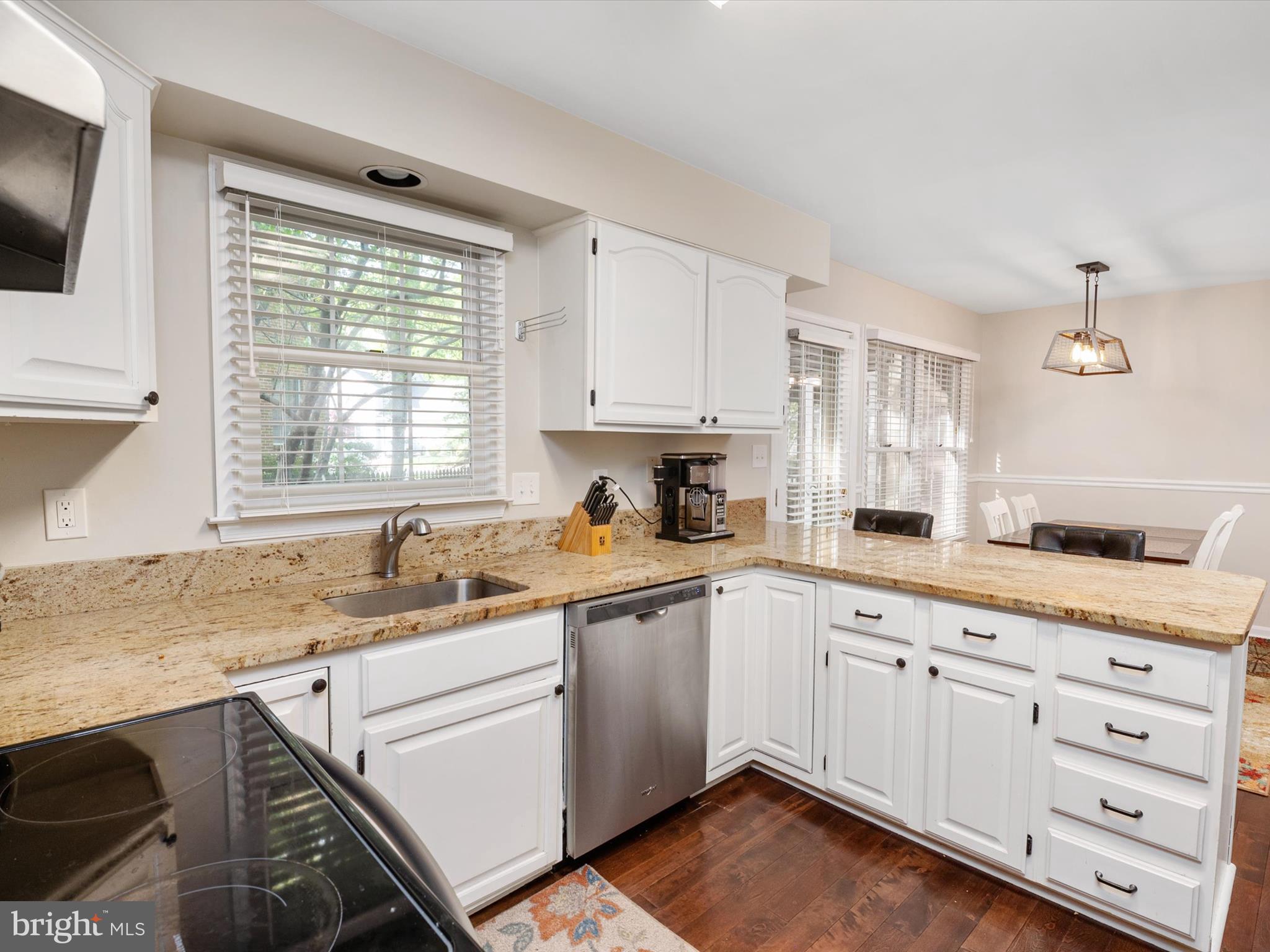 1711 Peartree Lane Crofton, MD 21114 - Photo 15 of 65 a kitchen with granite countertop white cabinets white appliances and sink