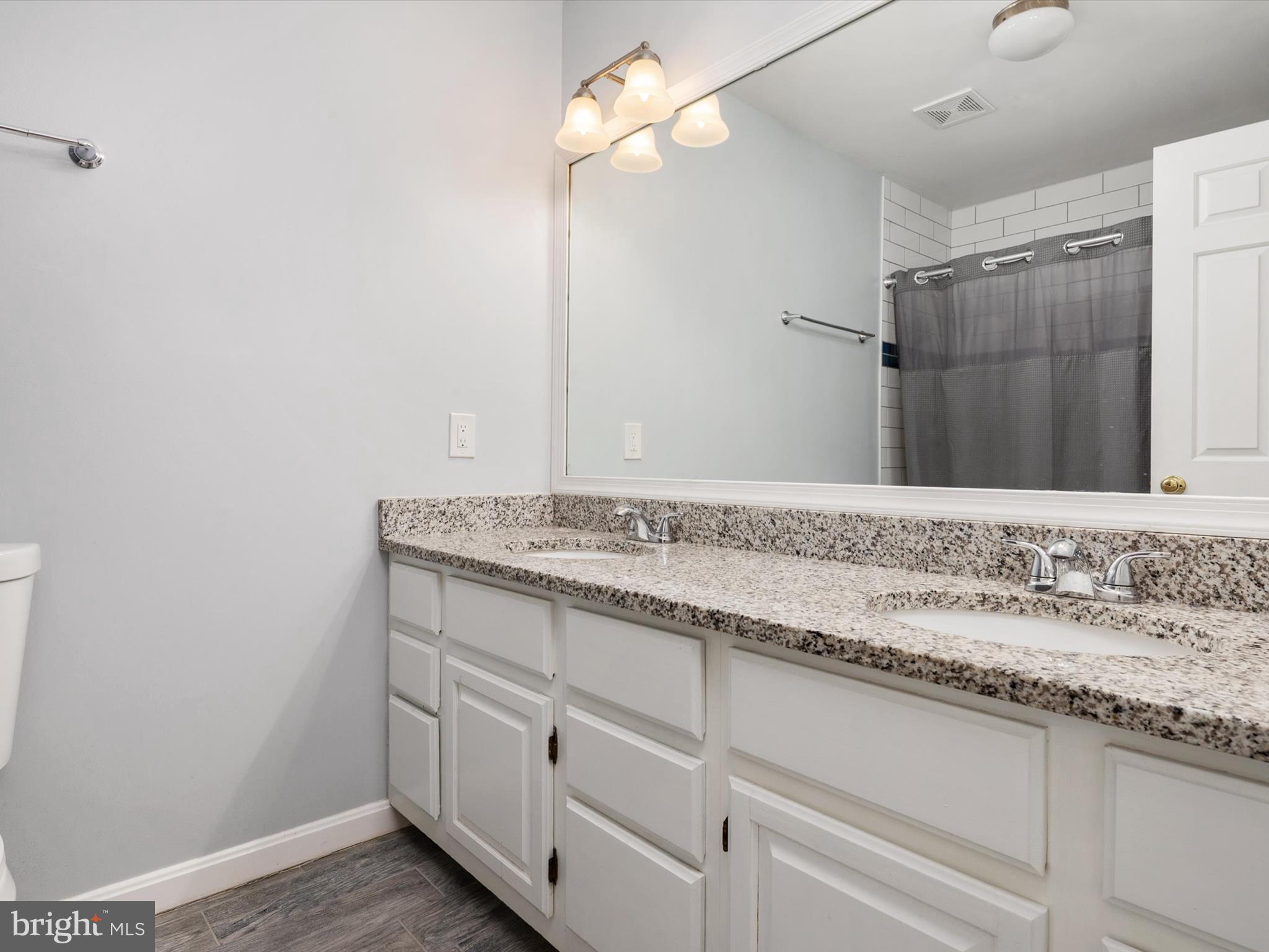 1711 Peartree Lane Crofton, MD 21114 - Photo 35 of 65 a bathroom with a granite countertop sink and a mirror