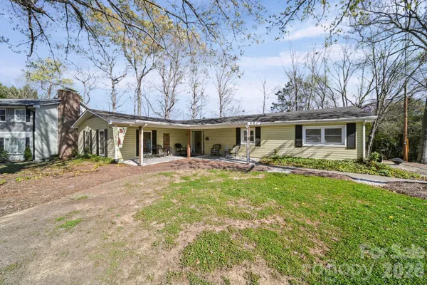 a front view of a house with yard porch and outdoor seating