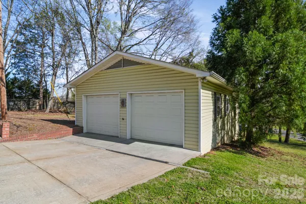 a front view of house with yard and tree