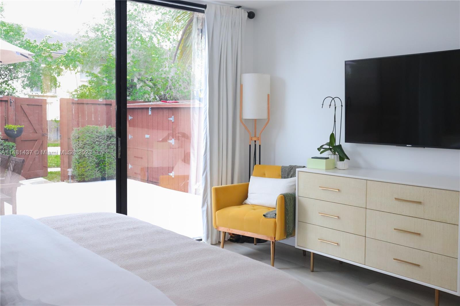 6704 Southwest 114th Place, Unit E Miami, FL 33173 - Photo 11 of 34 a living room with furniture and a flat screen tv