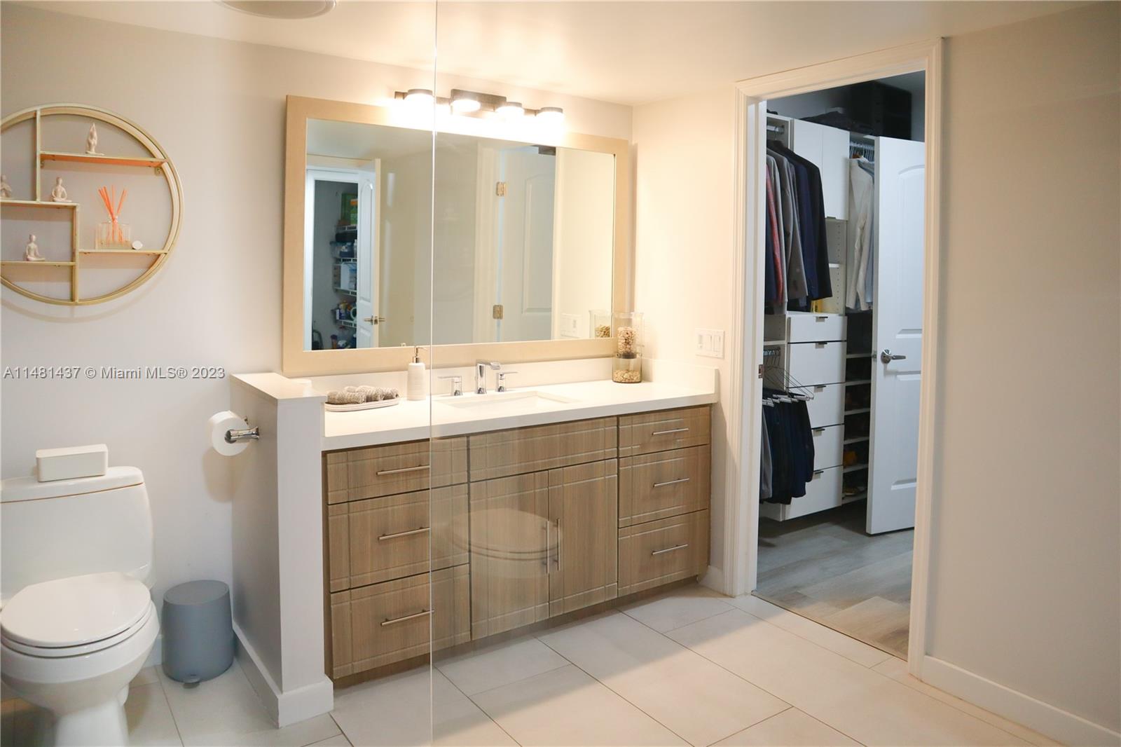 6704 Southwest 114th Place, Unit E Miami, FL 33173 - Photo 12 of 34 a bathroom with a double vanity sink mirror and toilet