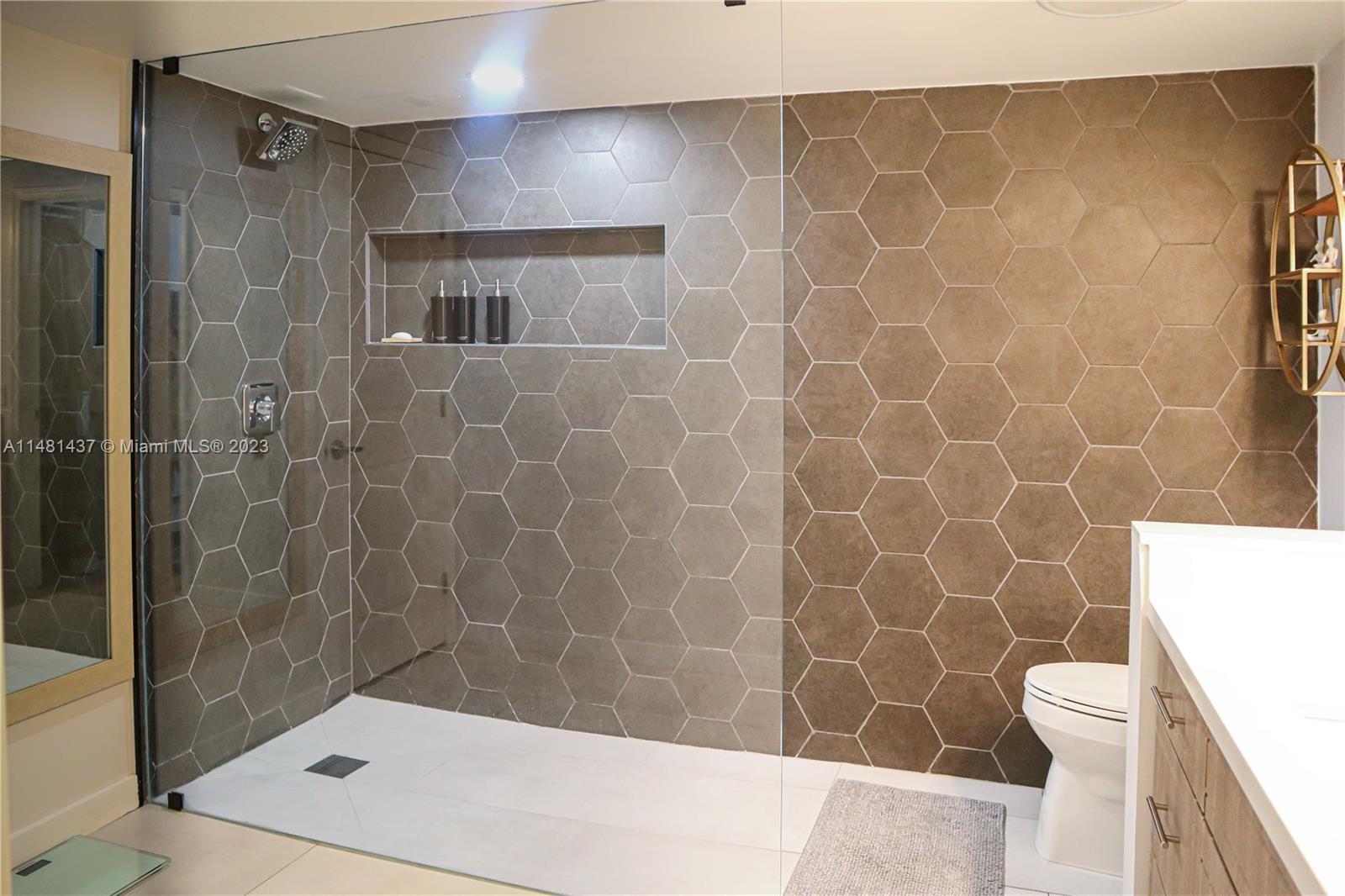 6704 Southwest 114th Place, Unit E Miami, FL 33173 - Photo 13 of 34 a bathroom with a shower and a toilet