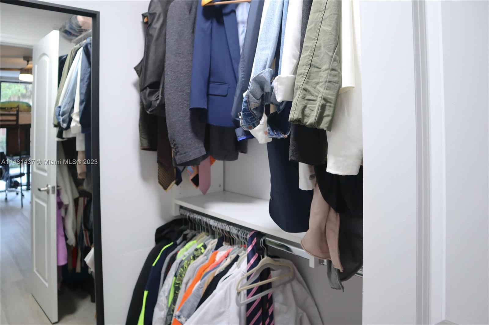 6704 Southwest 114th Place, Unit E Miami, FL 33173 - Photo 16 of 34 walk in closet with clothes and shoes