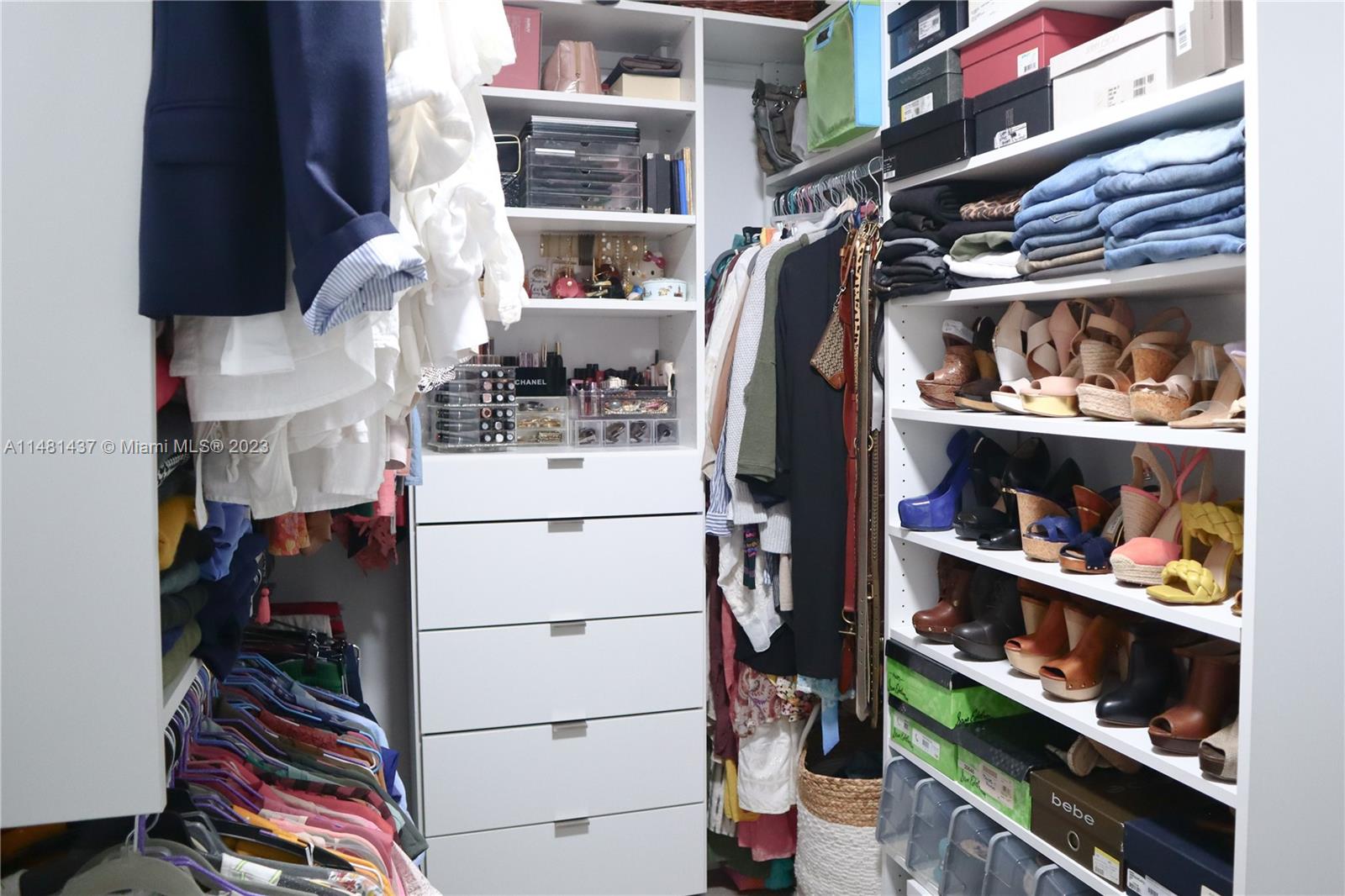 6704 Southwest 114th Place, Unit E Miami, FL 33173 - Photo 17 of 34 a view of walk in closet with clothes and shoes
