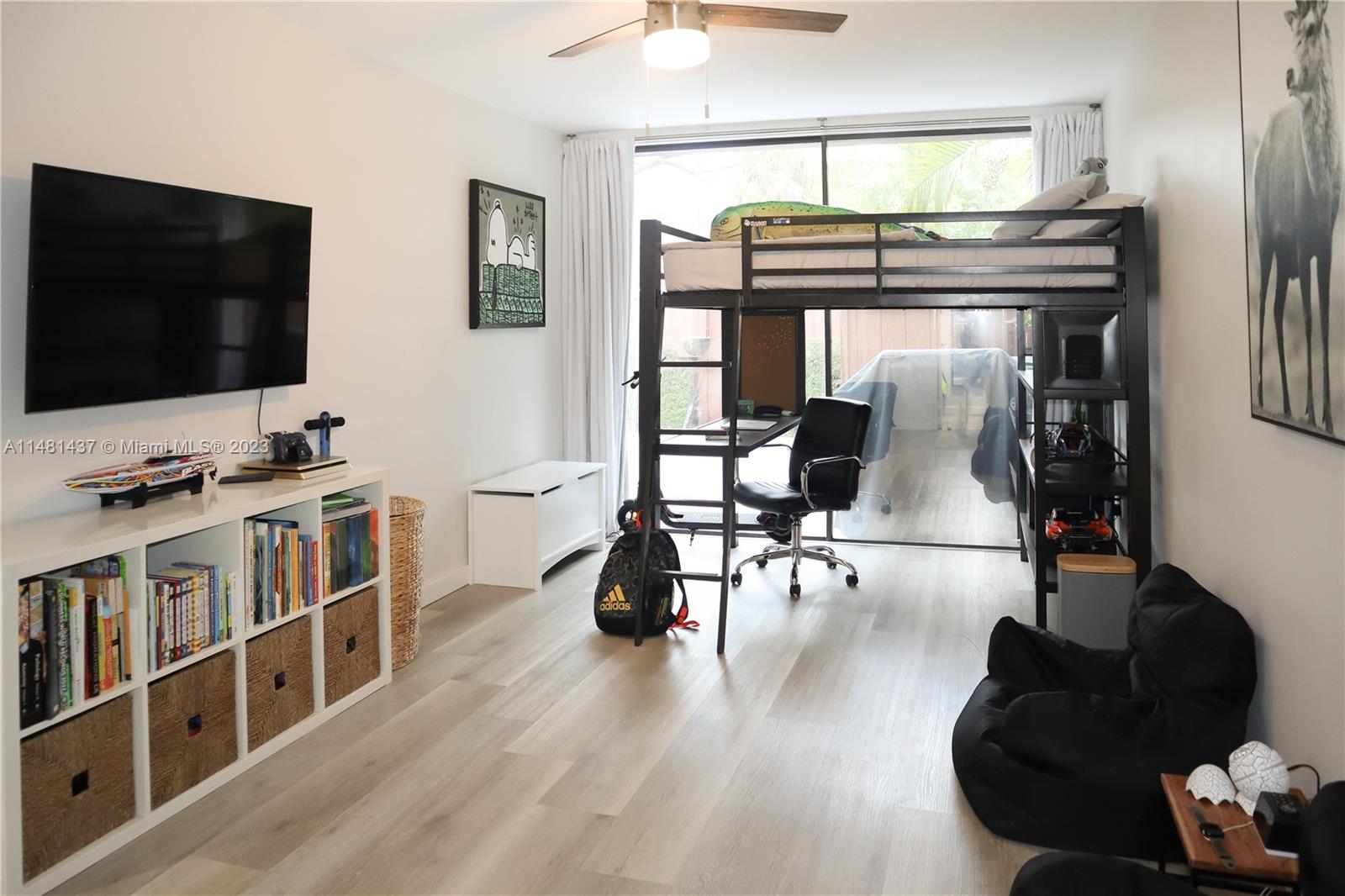 6704 Southwest 114th Place, Unit E Miami, FL 33173 - Photo 18 of 34 a living room with furniture and a flat screen tv