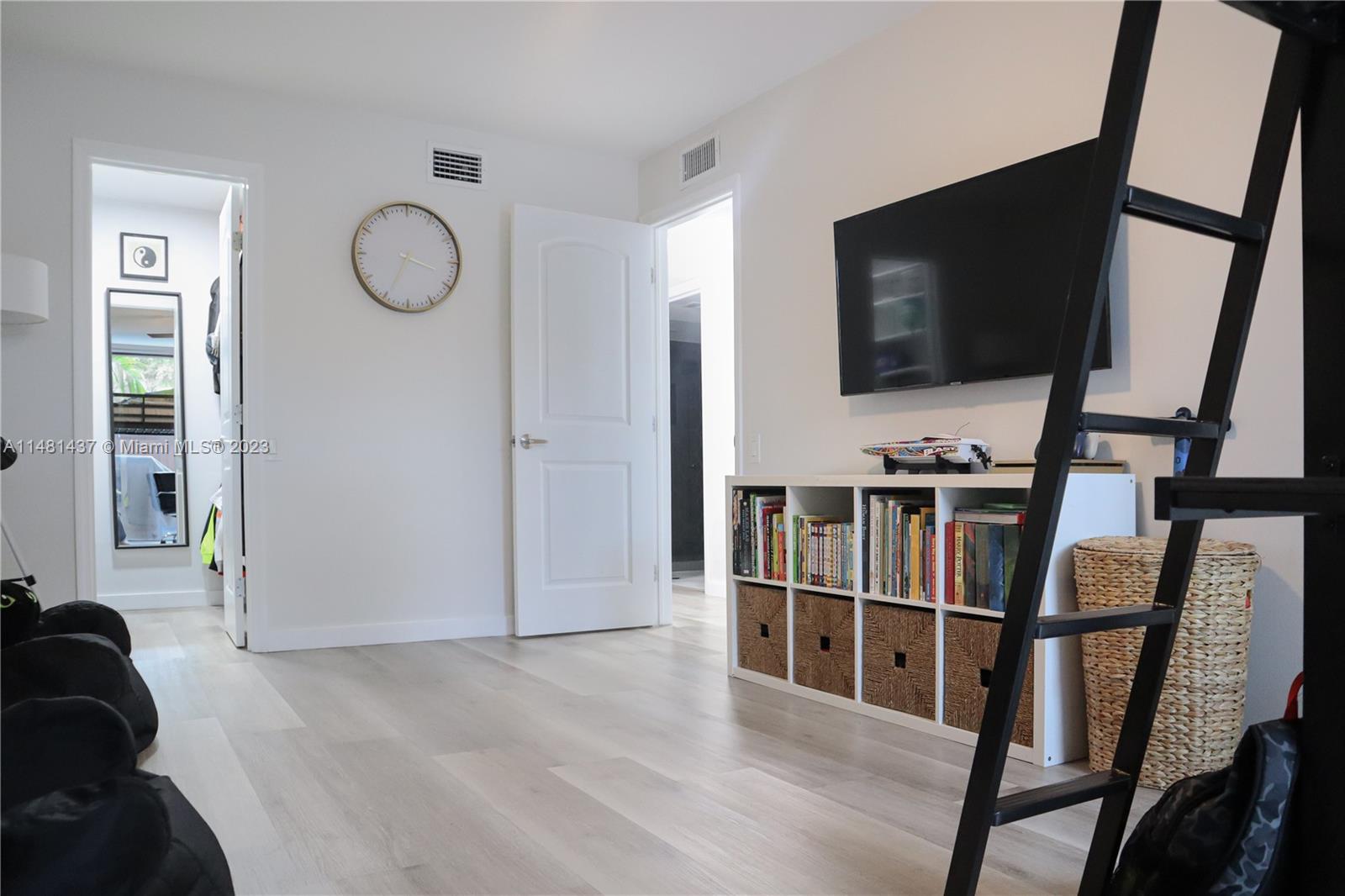 6704 Southwest 114th Place, Unit E Miami, FL 33173 - Photo 19 of 34 a view of a livingroom with furniture and windows