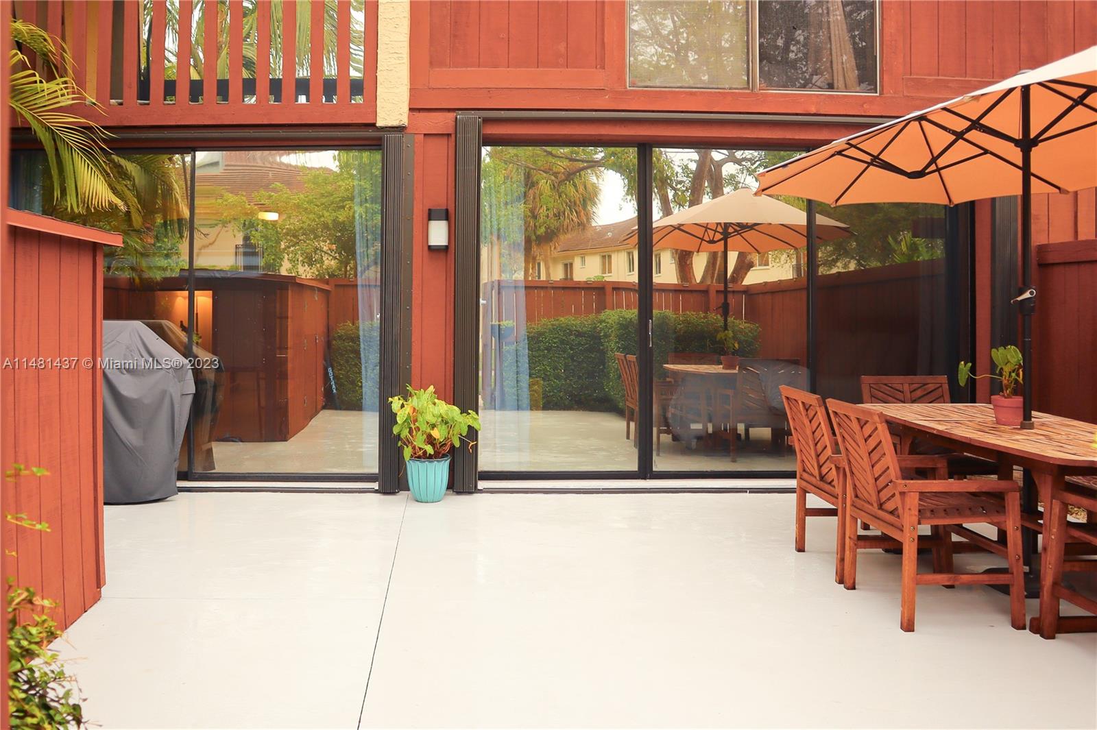 6704 Southwest 114th Place, Unit E Miami, FL 33173 - Photo 25 of 34 a view of a two chairs in the patio