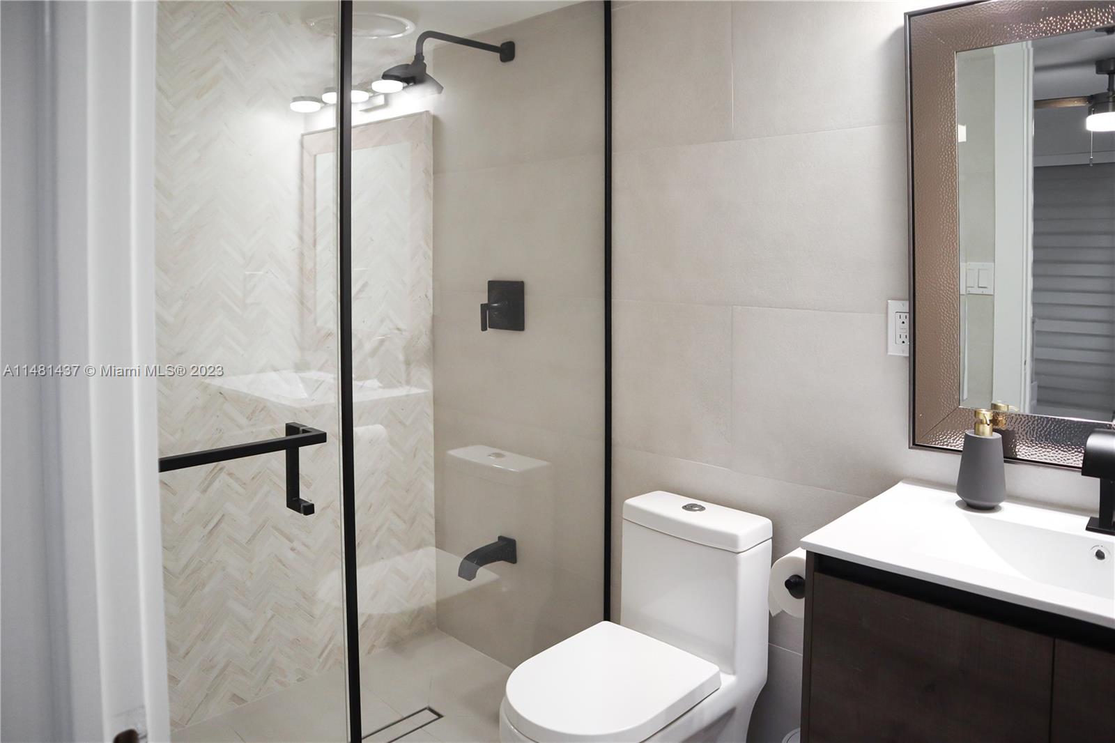 6704 Southwest 114th Place, Unit E Miami, FL 33173 - Photo 31 of 34 a bathroom with a sink toilet and shower