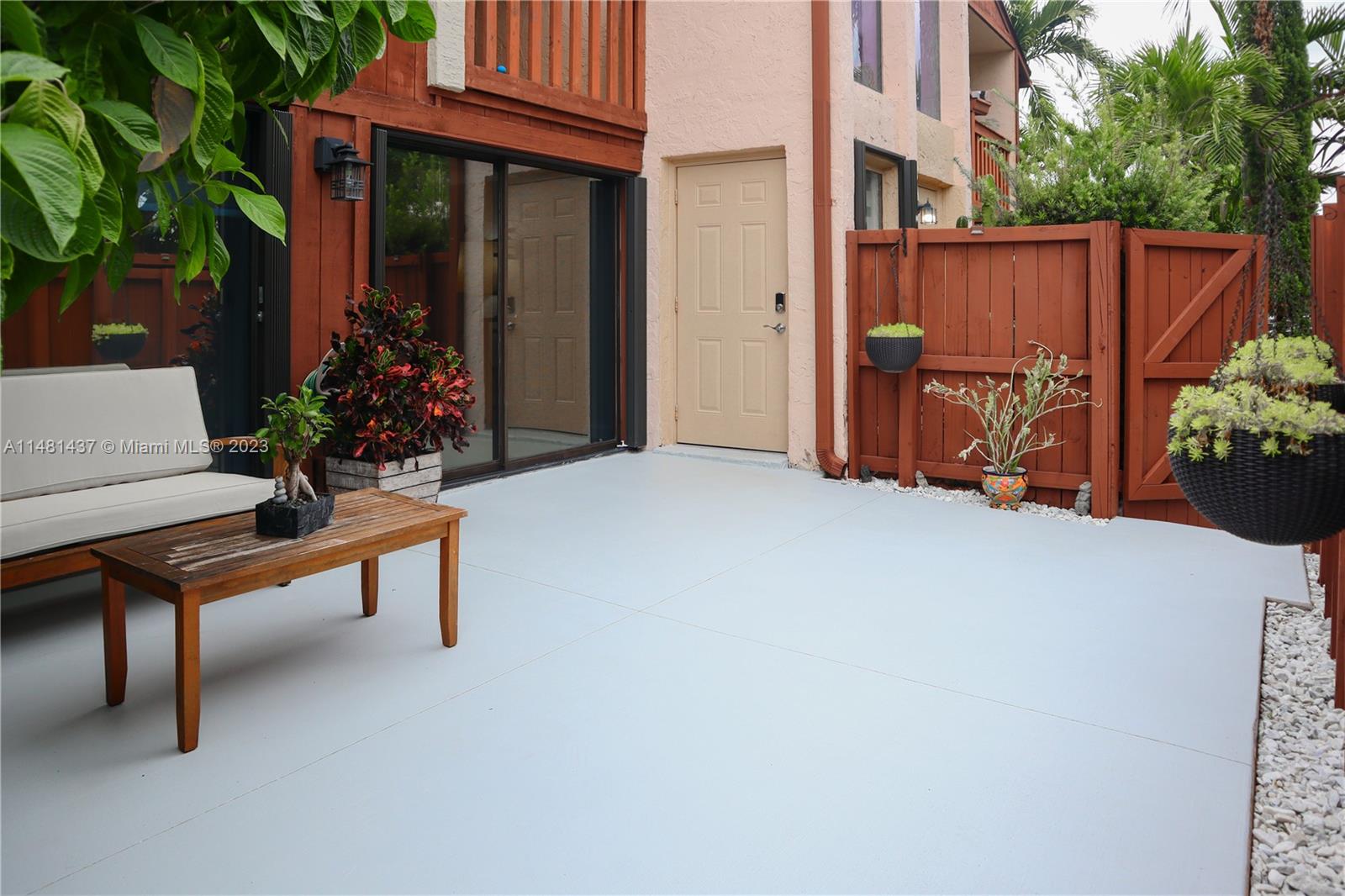 6704 Southwest 114th Place, Unit E Miami, FL 33173 - Photo 33 of 34 a view of an outdoor sitting area with brick walls