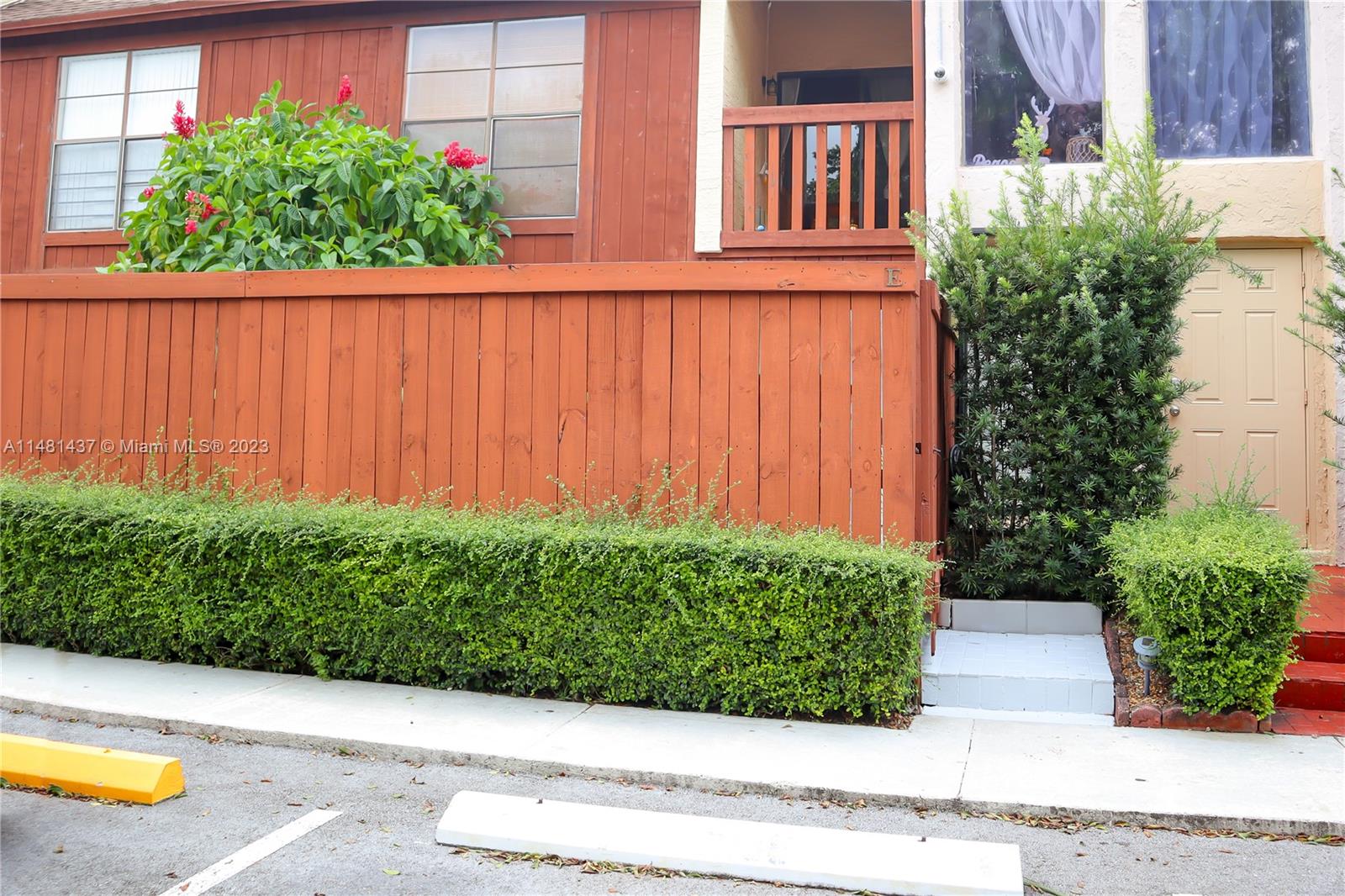 6704 Southwest 114th Place, Unit E Miami, FL 33173 - Photo 34 of 34 a view of a garden with plants and a bench