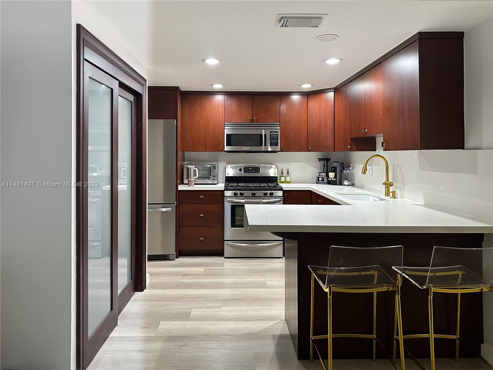 6704 Southwest 114th Place, Unit E Miami, FL 33173 - Photo 4 of 34 a kitchen with a sink cabinets and window
