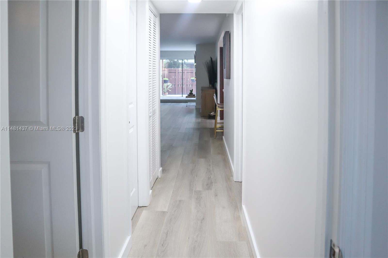 6704 Southwest 114th Place, Unit E Miami, FL 33173 - Photo 7 of 34 a view of a hallway with wooden floor