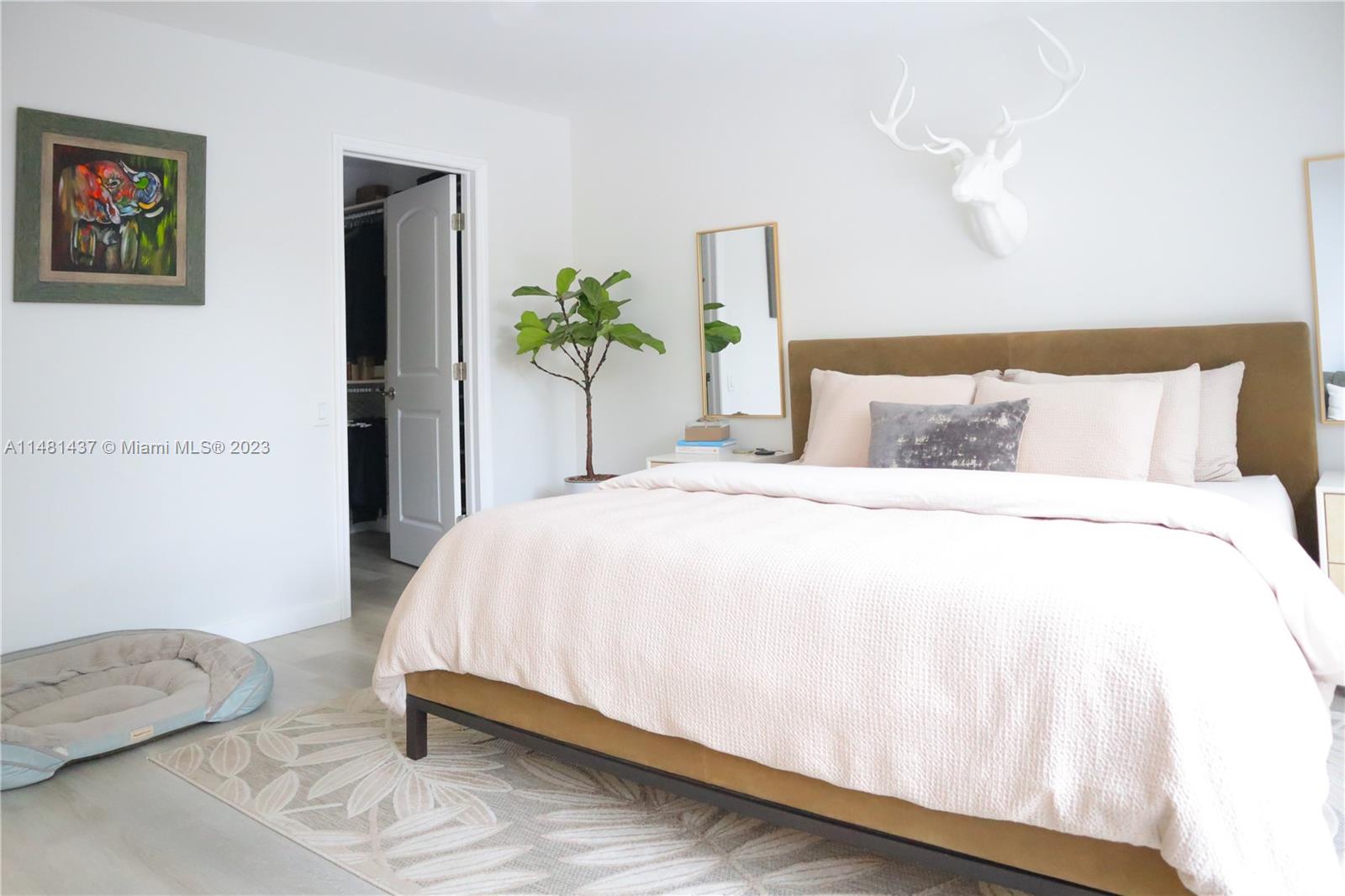 6704 Southwest 114th Place, Unit E Miami, FL 33173 - Photo 10 of 34 a bedroom with a bed and a potted plant