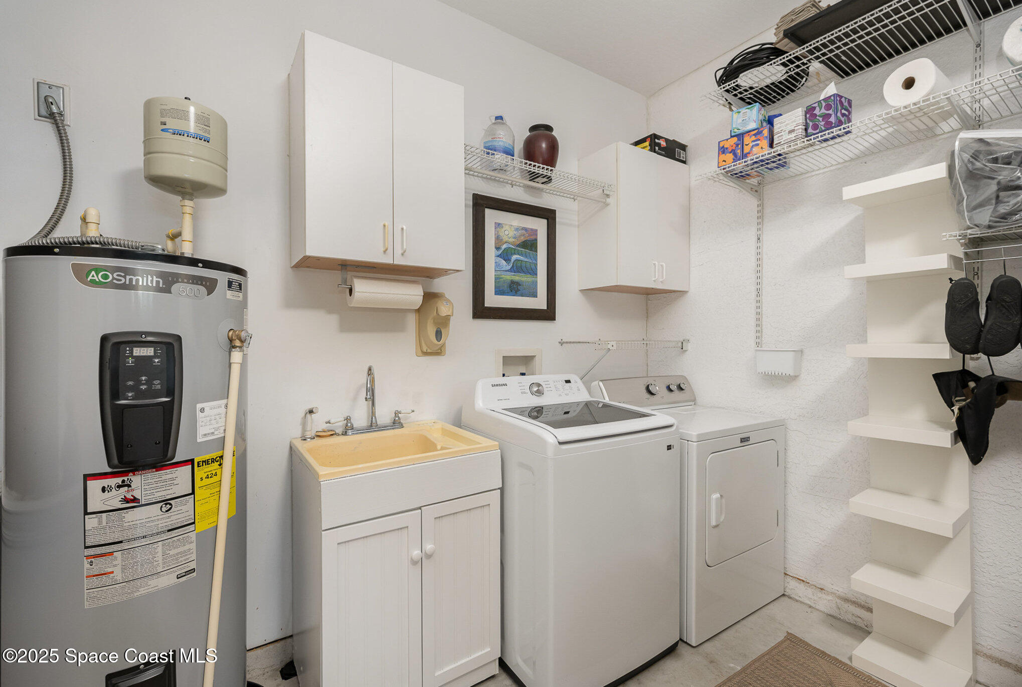 210 Sutton Street Rockledge, FL 32955 - Photo 27 of 39 Laundry Area w/ Cabinets & Utility Sink