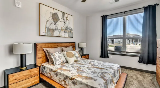 a bedroom with a bed and a window