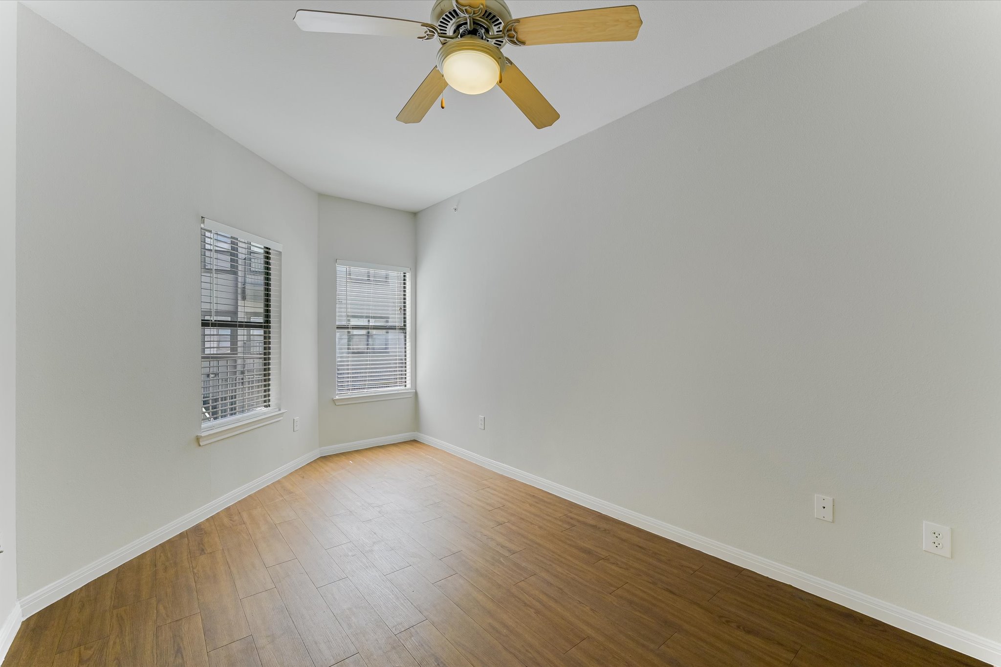 2502 Leon Street, Unit 301 Austin, TX 78705 - Photo 9 of 15 Main bedroom with ceiling fan. Space is sufficient for bed plus desk.
