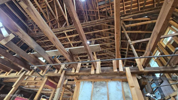 a view of a porch with furniture and floor to ceiling window