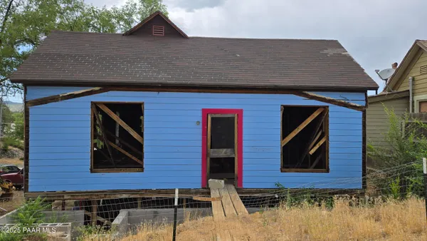 a view of a house with a patio and a yard
