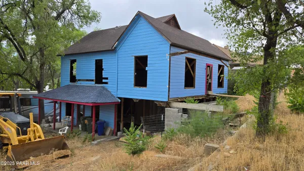 a view of a house with a patio and a backyard