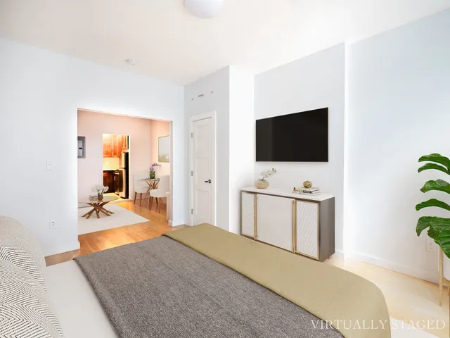 a bedroom with a bed and a flat screen tv