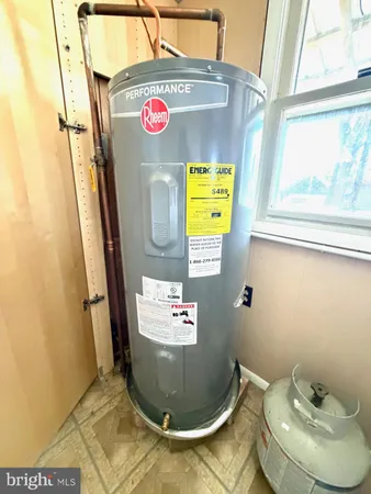 a view of a house with a big yard and large tree