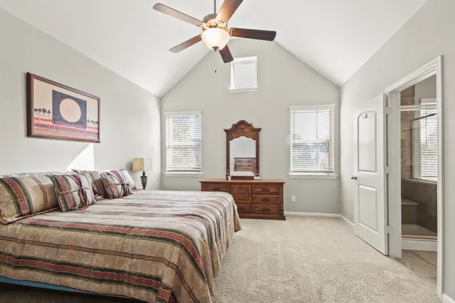 a bedroom with a large bed and a chandelier