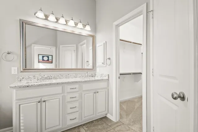 a bathroom with a granite countertop sink mirror and a