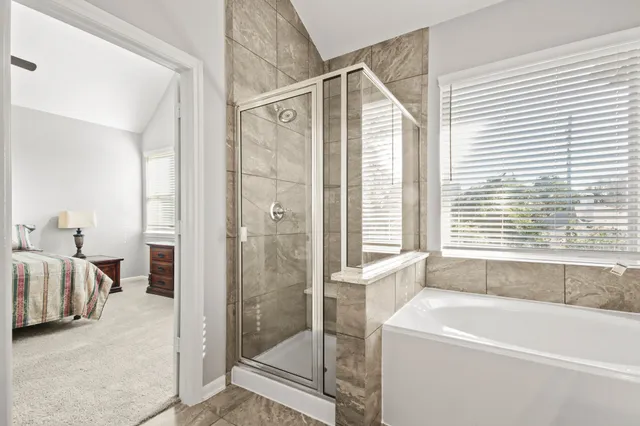 a bathroom with a bathtub and a shower