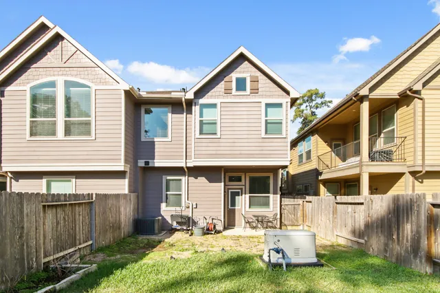 a front view of a house with a yard outdoor seating and garage