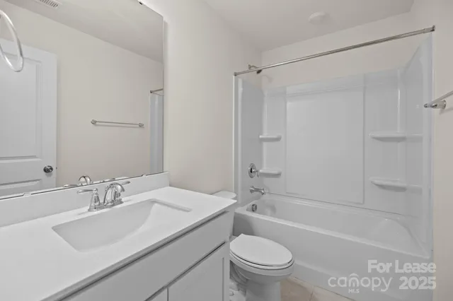 a bathroom with a sink toilet vanity and shower