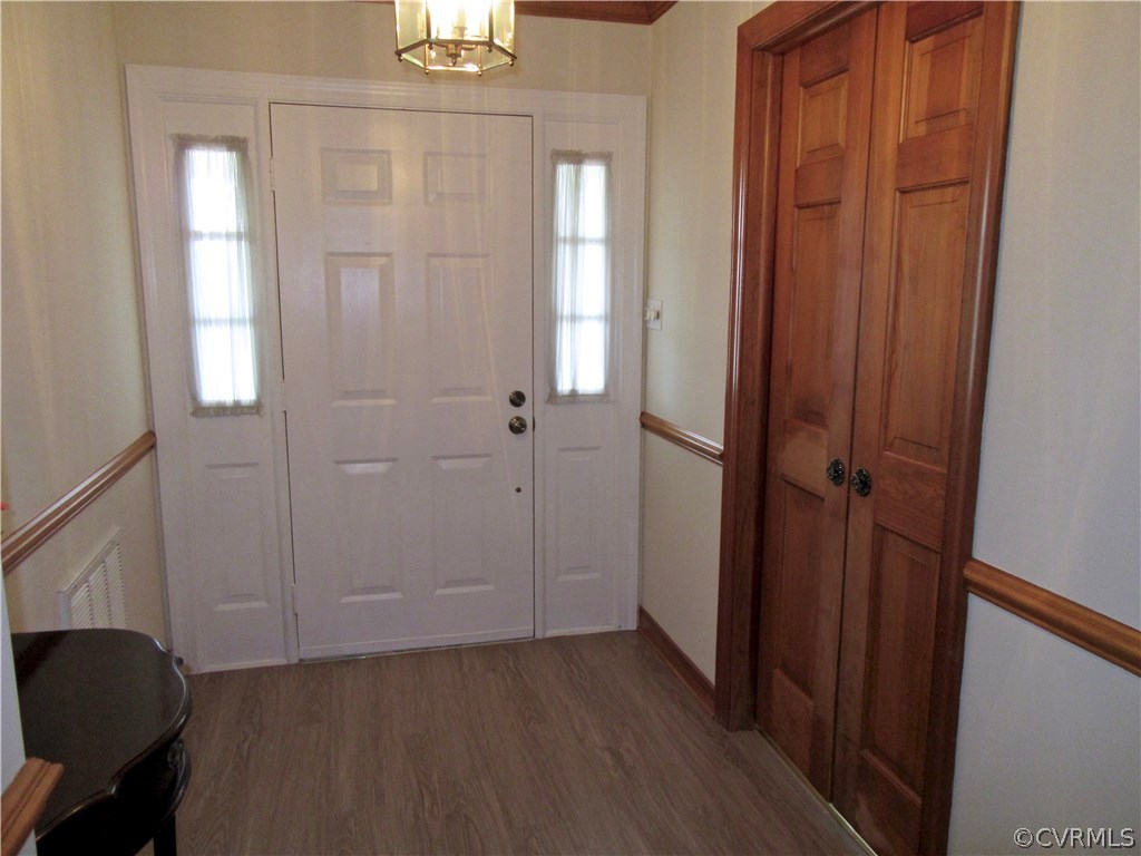3092 Lowry Road Columbia, VA 23038 - Photo 3 of 34 an empty room with wooden floor and windows