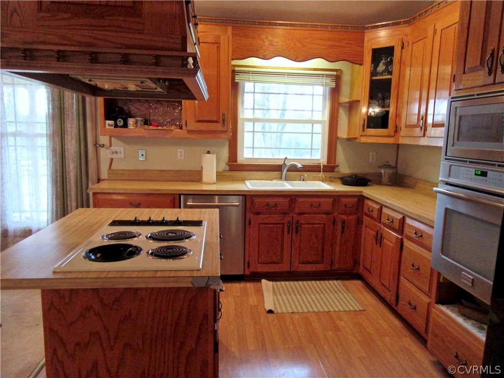 3092 Lowry Road Columbia, VA 23038 - Photo 4 of 34 a kitchen with a sink a stove a refrigerator and wooden cabinets