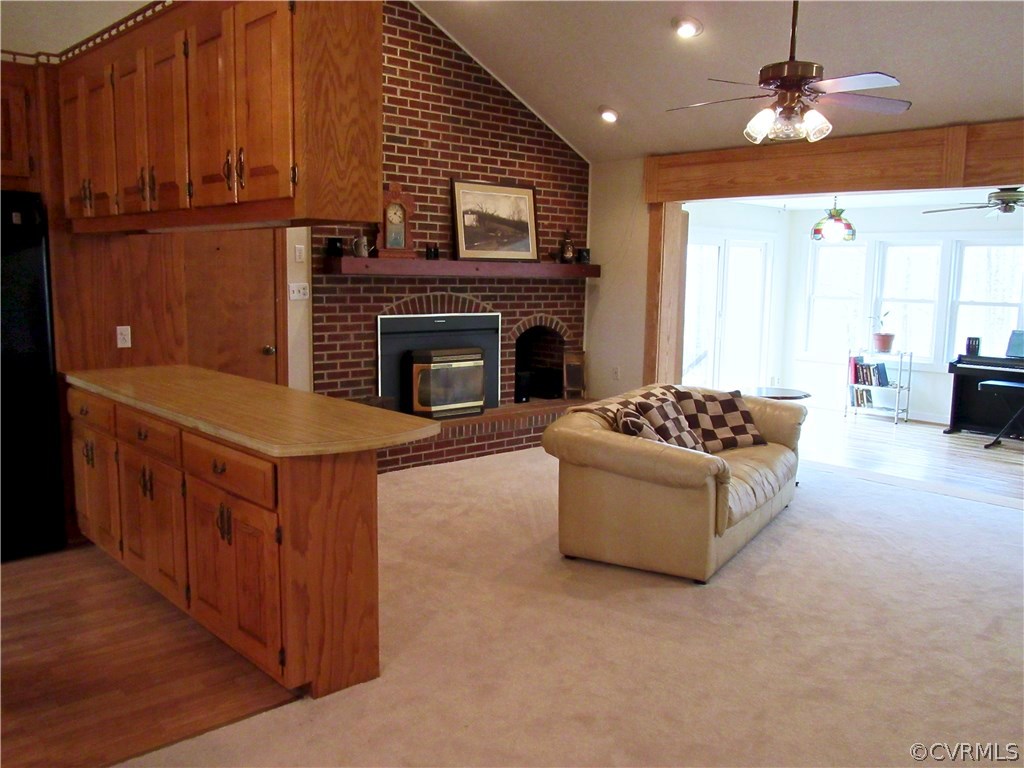 3092 Lowry Road Columbia, VA 23038 - Photo 34 of 34 a living room with furniture a fireplace and a ceiling fan