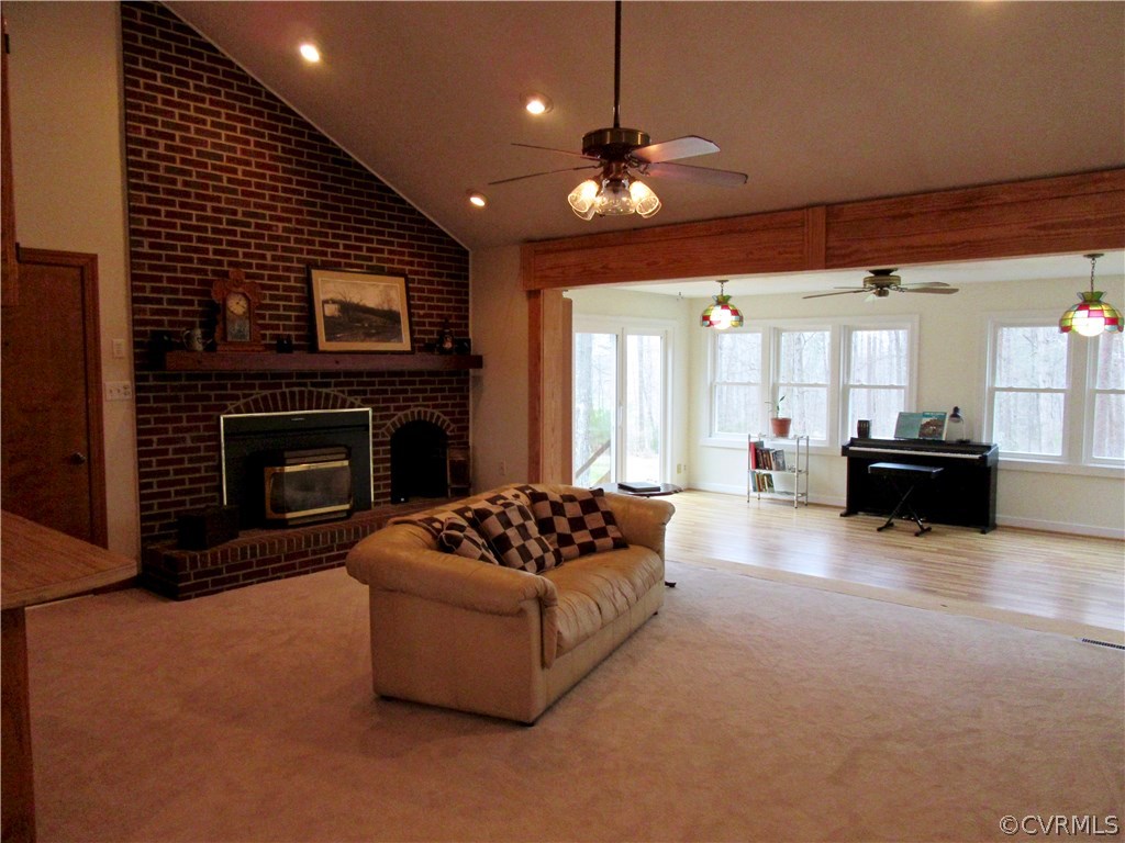 3092 Lowry Road Columbia, VA 23038 - Photo 8 of 34 a living room with furniture a fireplace and a flat screen tv