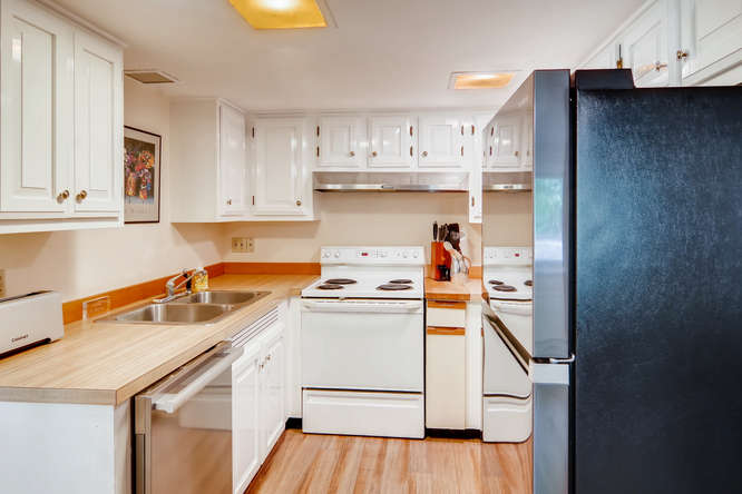 345 N Road Chilmark, MA 02535 - Photo 13 of 26 a kitchen with a sink a stove and cabinets
