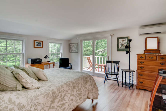 345 N Road Chilmark, MA 02535 - Photo 17 of 26 a bedroom with a bed and wooden floor