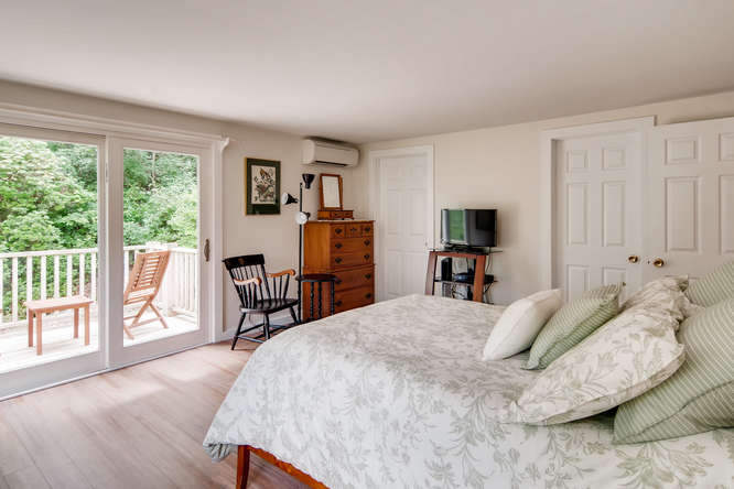 345 N Road Chilmark, MA 02535 - Photo 18 of 26 a bed room with a bed and a large window