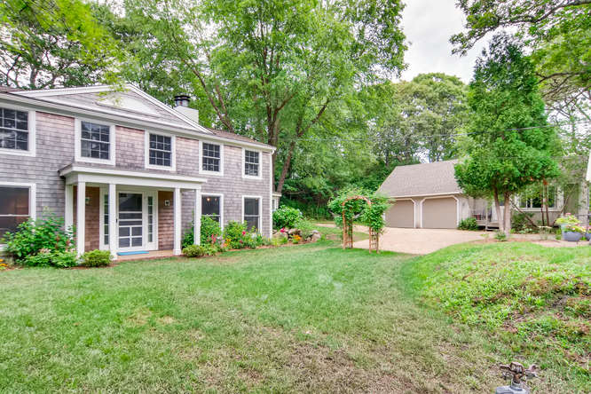 345 N Road Chilmark, MA 02535 - Photo 5 of 26 a front view of a house with a yard and trees