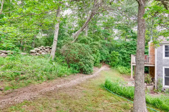 345 N Road Chilmark, MA 02535 - Photo 7 of 26 a backyard of a house with a yard and outdoor seating