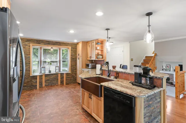 a kitchen with stainless steel appliances granite countertop a stove and a sink