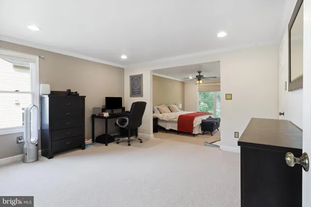 a bedroom with a bed and a desk