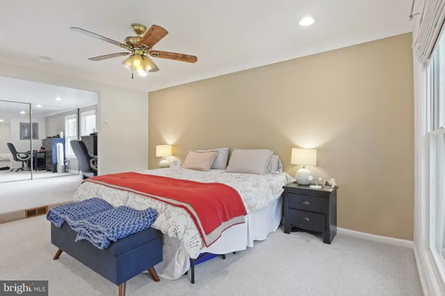 a spacious bedroom with a bed and a chandelier