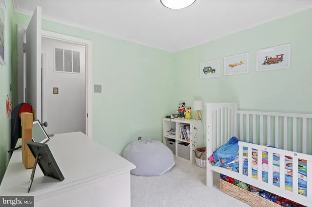a bedroom with baby bed toys and a baby crib