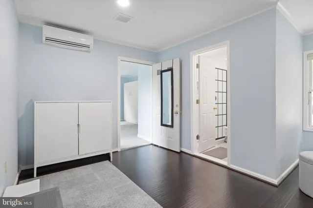 an empty room with wooden floor and white walls