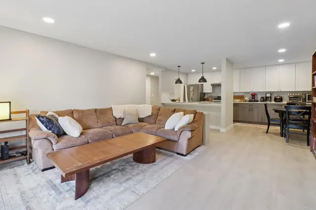 a living room with furniture and kitchen view