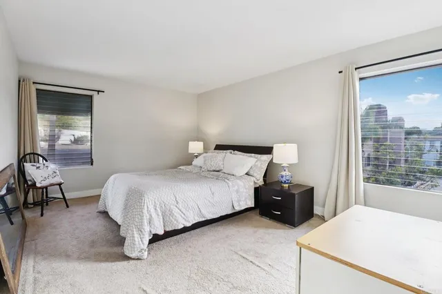 a bedroom with a bed and window